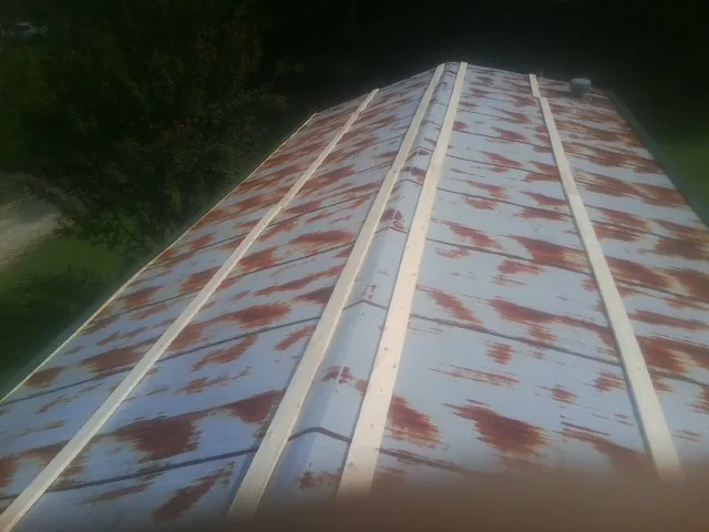 Rusted metal roof panels with new wood purlins before replacement — Storm Damage Roof Repair in Tiptonville by Roofing Brothers