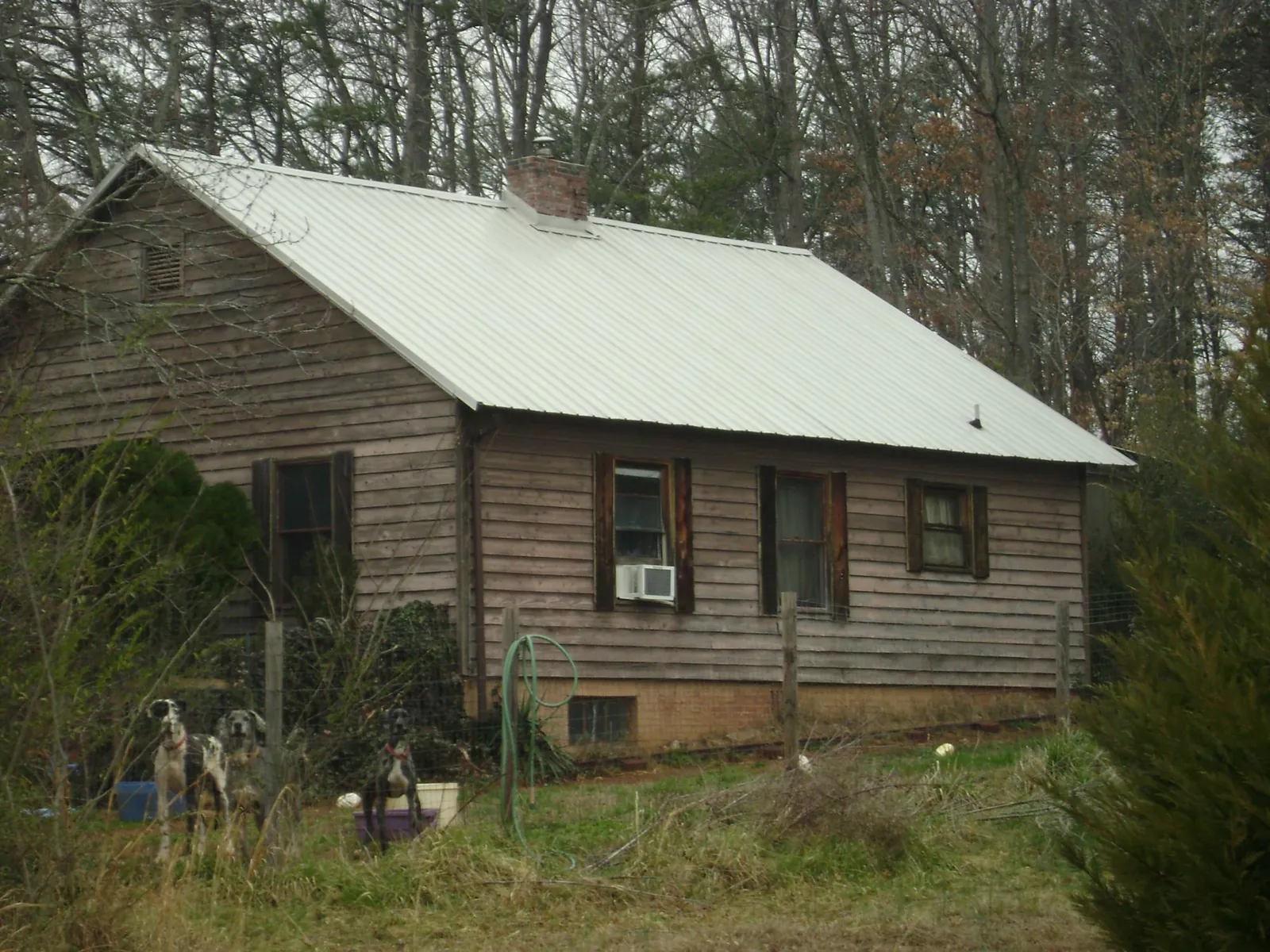 White metal roof on an old wood sided farmhouse, from a Metal Roof Installation job in Tiptonville